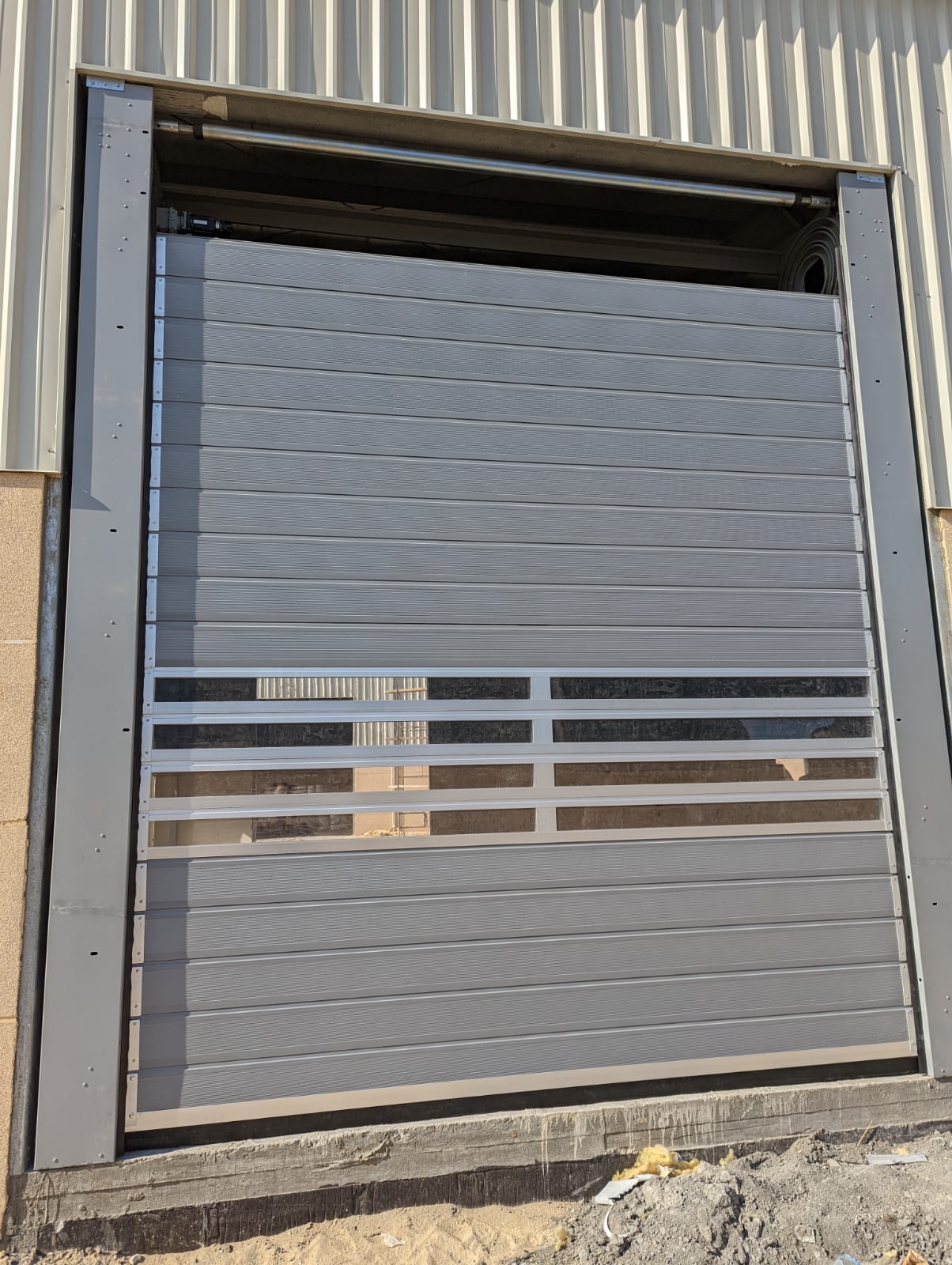 What are the cost advantages of rigid fast doors over traditional doors?